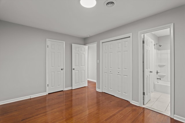 2131 Reedale Ave, Augusta, GA 30906 - unfurnished bedroom featuring wood finished floors, baseboards, and ensuite bathroom