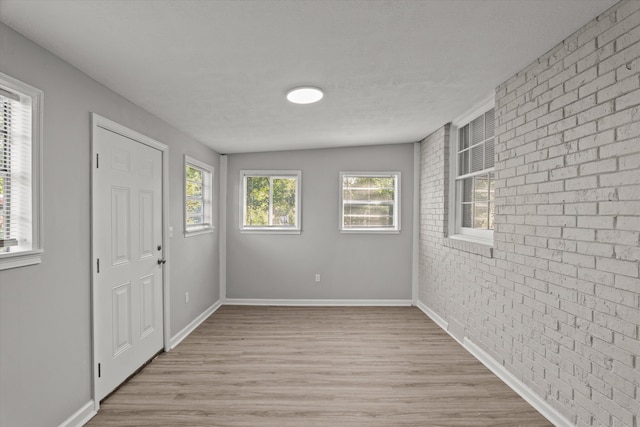 2131 Reedale Ave, Augusta, GA 30906 - foyer featuring brick wall, wood finished floors, and baseboards