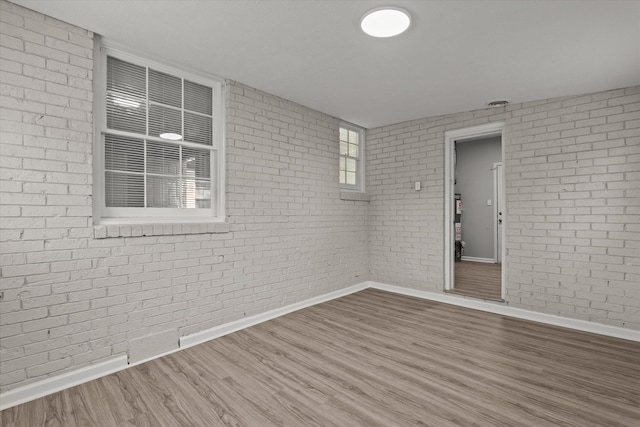 2131 Reedale Ave, Augusta, GA 30906 - spare room featuring brick wall, baseboards, and wood finished floors