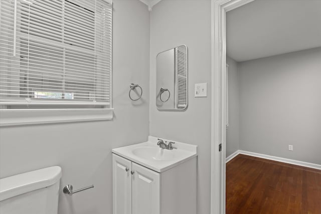 2131 Reedale Ave, Augusta, GA 30906 - bathroom featuring toilet, vanity, wood finished floors, and baseboards