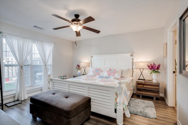 bedroom with ceiling fan and dark hardwood / wood-style floors