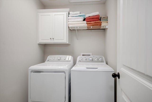 laundry area with cabinets and washer and dryer