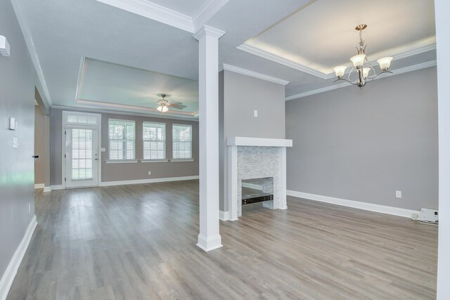 809 Richards Ct, Grovetown, GA 30813 - unfurnished living room featuring a tray ceiling, a ceiling fan, wood finished floors, crown molding, and a chandelier