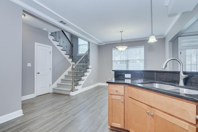 809 Richards Ct, Grovetown, GA 30813 - kitchen with dark stone countertops, decorative light fixtures, crown molding, and light wood-style flooring