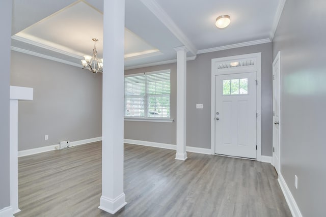 809 Richards Ct, Grovetown, GA 30813 - foyer entrance with wood finished floors, a chandelier, crown molding, a raised ceiling, and decorative columns