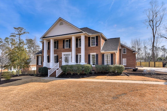 greek revival inspired property with a front lawn