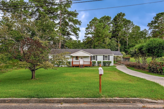 ranch-style house featuring covered porch and a front yard