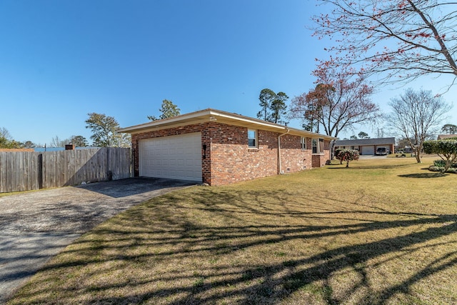 view of property exterior with fence, an attached garage, aphalt driveway, a lawn, and brick siding