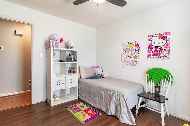 bedroom with a ceiling fan, baseboards, and wood finished floors