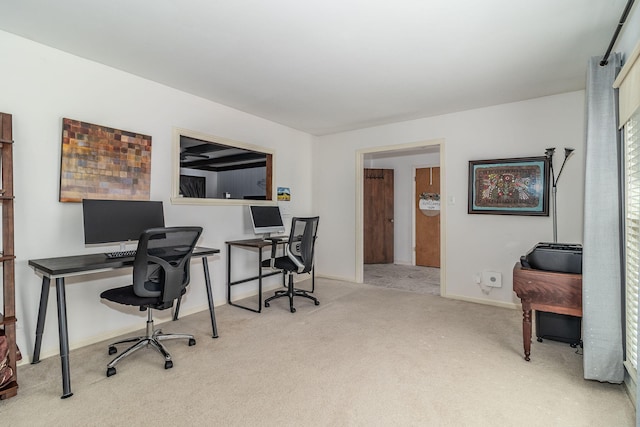 carpeted home office with baseboards