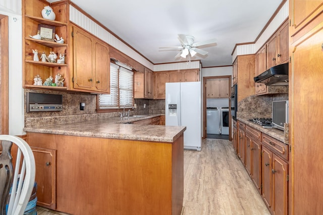 kitchen featuring under cabinet range hood, open shelves, a sink, white refrigerator with ice dispenser, and ceiling fan