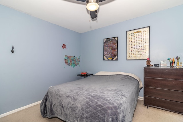 carpeted bedroom with a ceiling fan and baseboards