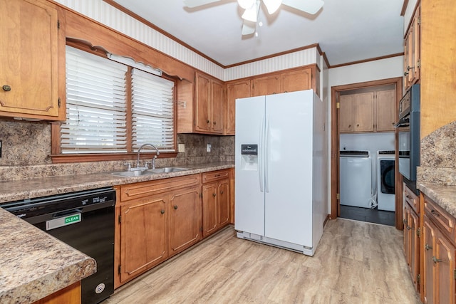 kitchen with washer and dryer, a sink, ceiling fan, white fridge with ice dispenser, and dishwasher