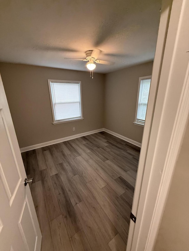 2216 Martin Rd, Augusta, GA 30906 - empty room with healthy amount of natural light, dark wood-type flooring, ceiling fan, and baseboards
