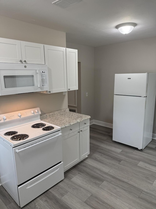 2216 Martin Rd, Augusta, GA 30906 - kitchen featuring white appliances, white cabinetry, light wood-style floors, and baseboards