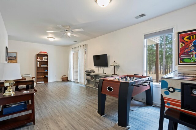 game room with a ceiling fan, baseboards, visible vents, and wood finished floors