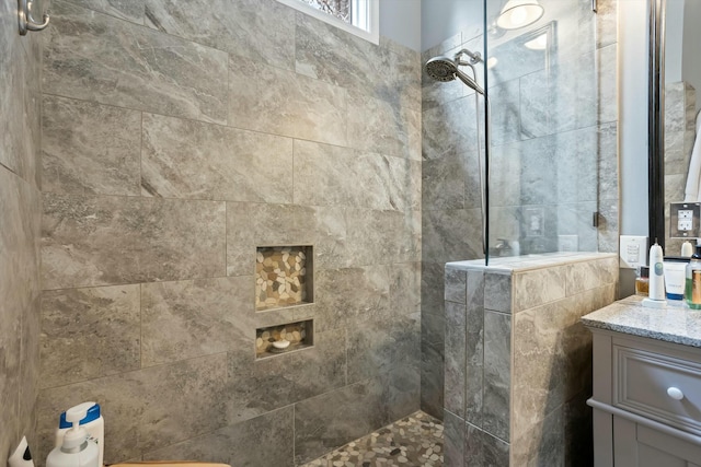 bathroom with vanity and a walk in shower