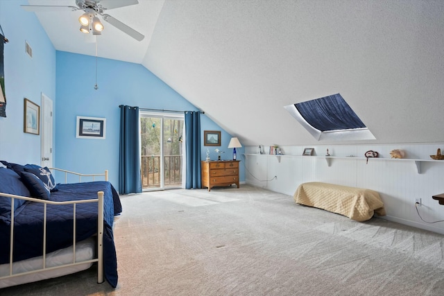 bedroom with carpet floors, visible vents, vaulted ceiling, and a textured ceiling