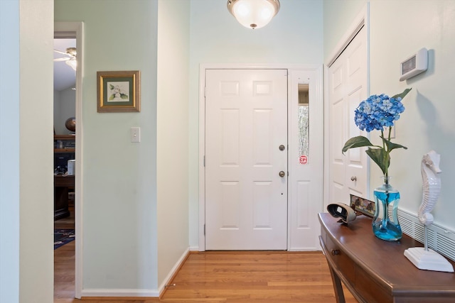 entrance foyer with light wood finished floors and baseboards