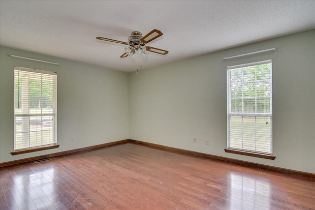 spare room featuring light wood-type flooring and ceiling fan