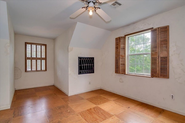 bonus room featuring plenty of natural light, ceiling fan, and lofted ceiling