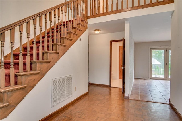 stairway featuring parquet floors