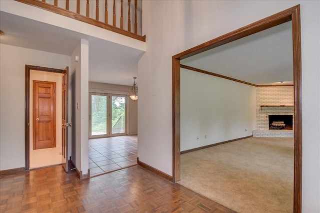 unfurnished living room with a fireplace and parquet floors