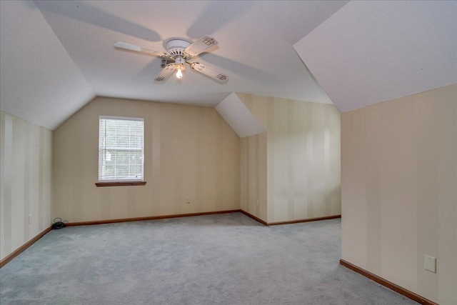 bonus room featuring light carpet, vaulted ceiling, and ceiling fan