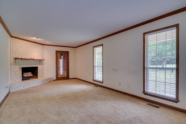 unfurnished living room with light colored carpet, ornamental molding, and a brick fireplace