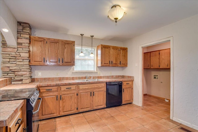 kitchen featuring sink, tile countertops, pendant lighting, light tile patterned flooring, and black appliances