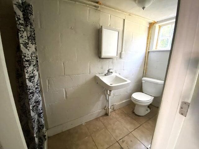 bathroom featuring tile patterned floors and toilet