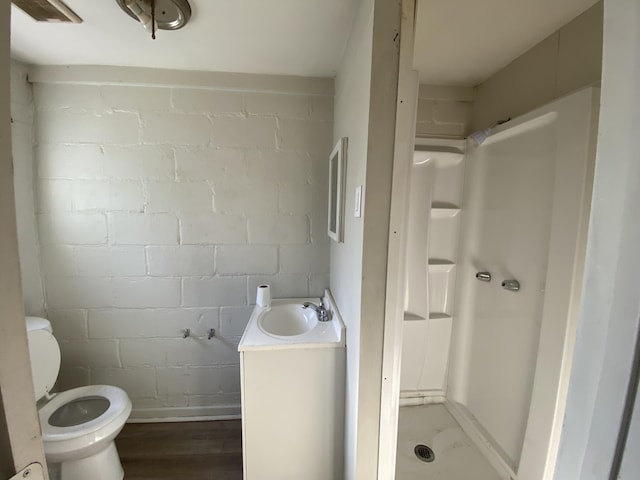 bathroom featuring vanity, wood-type flooring, walk in shower, and toilet