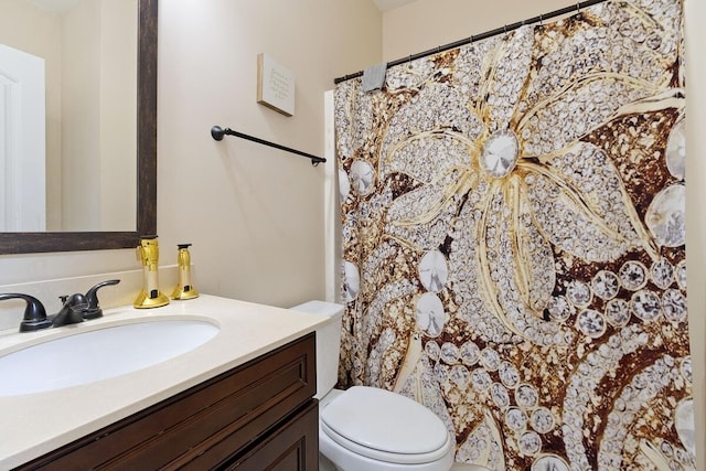 bathroom featuring vanity and toilet