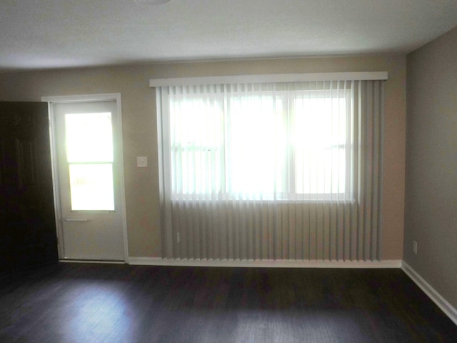 unfurnished room with dark hardwood / wood-style floors