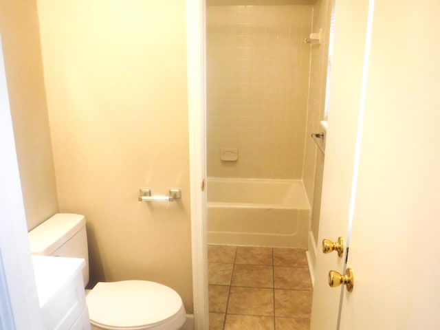 full bathroom with tile patterned floors, vanity, toilet, and tiled shower / bath combo