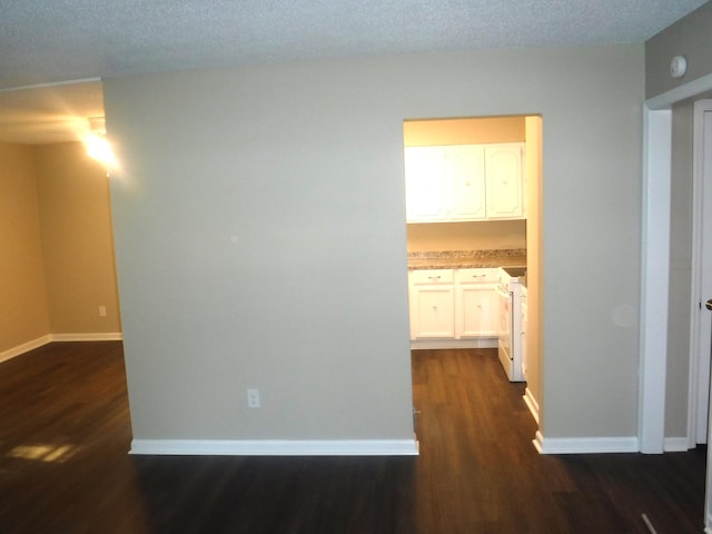 interior space with a textured ceiling and dark hardwood / wood-style flooring