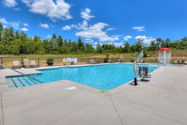 pool with fence and a patio