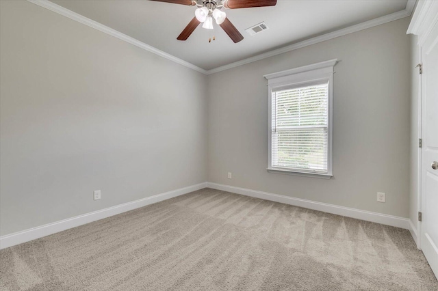 carpeted empty room featuring ceiling fan and crown molding