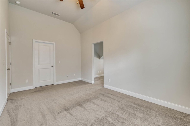 spare room featuring light carpet, ceiling fan, and lofted ceiling