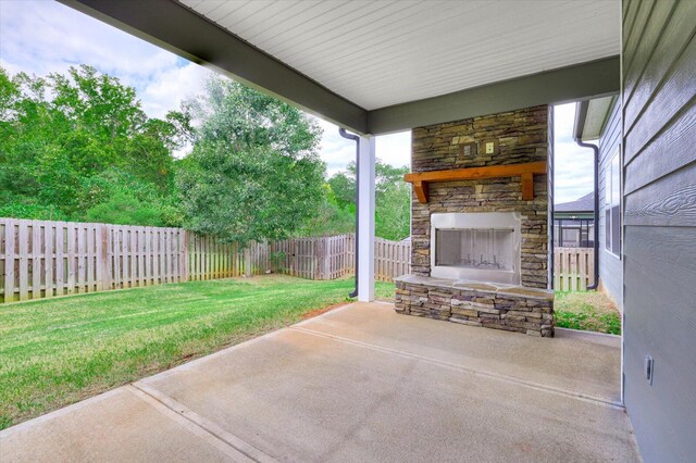 view of patio with an outdoor stone fireplace