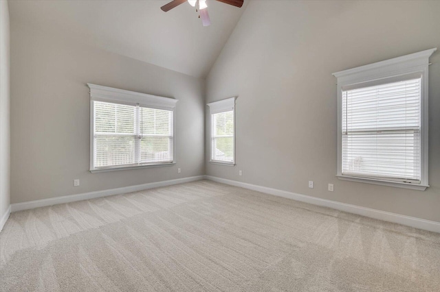 carpeted spare room with high vaulted ceiling and ceiling fan