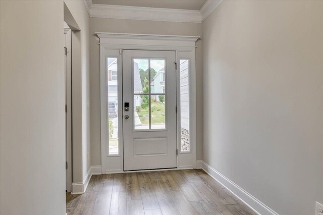 foyer featuring crown molding and light hardwood / wood-style floors