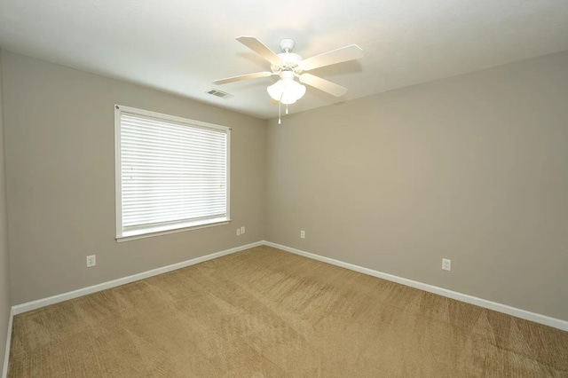 carpeted empty room featuring ceiling fan