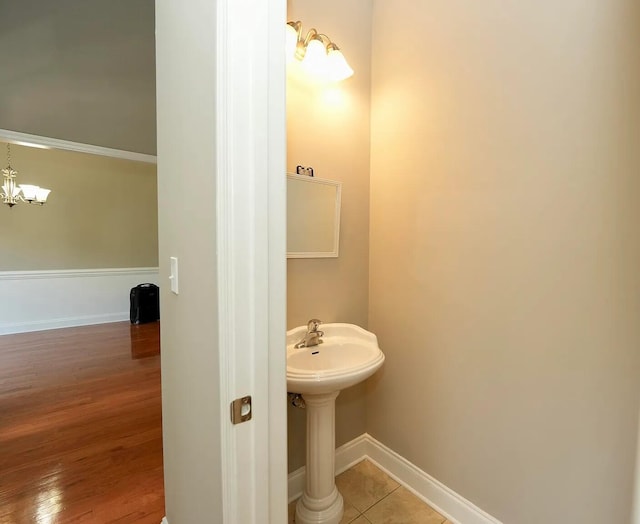 bathroom featuring tile patterned floors and a chandelier