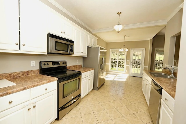 kitchen featuring white cabinetry, appliances with stainless steel finishes, sink, and hanging light fixtures