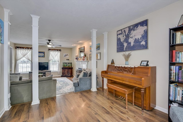 864 Chase Rd, Evans, GA 30809 - living room featuring ornate columns, wood finished floors, ceiling fan, and baseboards