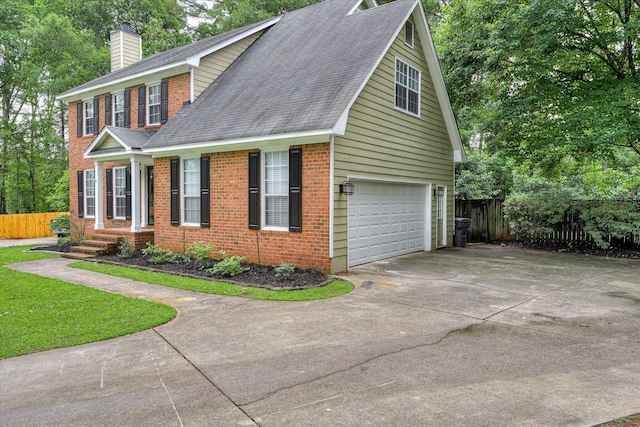864 Chase Rd, Evans, GA 30809 - view of front facade with a chimney, brick siding, an attached garage, concrete driveway, and roof with shingles