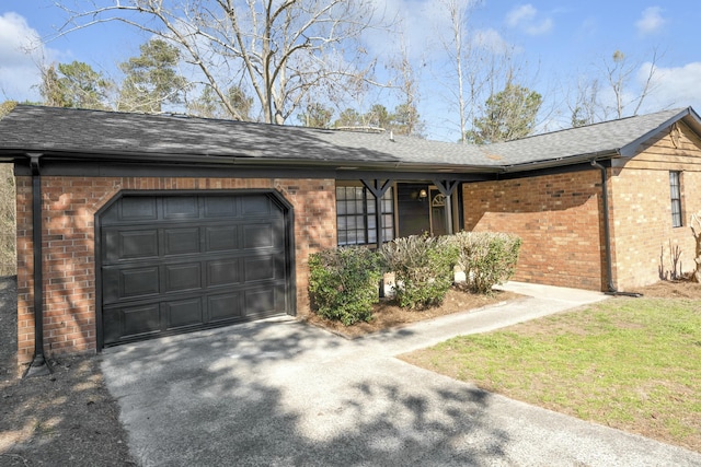 single story home featuring brick siding, an attached garage, a shingled roof, and driveway