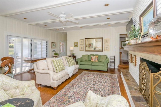 3034 Bransford Rd, Augusta, GA 30909 - living room featuring a ceiling fan, beamed ceiling, a brick fireplace, and wood finished floors