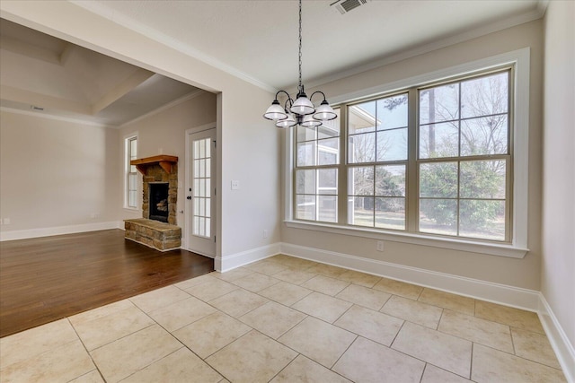 unfurnished dining area with light tile patterned floors, a fireplace, visible vents, baseboards, and ornamental molding